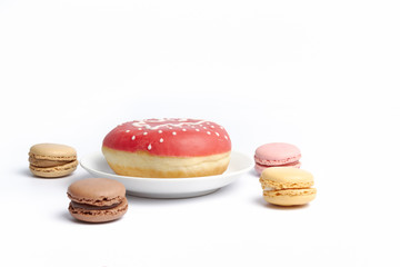 decorative donuts and macrons on a white surface