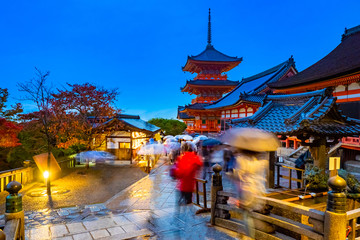 Fototapeta na wymiar Japan. Kyoto. Temple of pure water in Japan. Kiyomizu Dera Temple. People with umbrellas walk at the temple of pure water in Kyoto. Religious building. Architecture Of Japan. Evening in Kyoto.