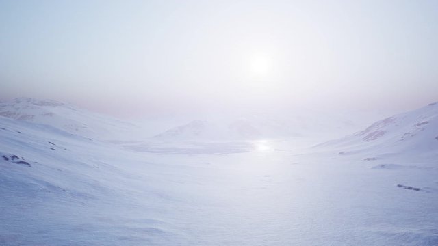 Aerial Landscape of snowy mountains and icy shores in Antarctica