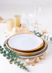 Decorated Christmas table setting, light background. Christmas and New Year holidays concept. Copy space.