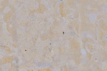 Background of porous limestone stone of orange color. Orange tone stone texture. The texture of the Sandstone surface.