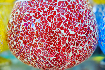 Red glass lamp on the Medina in Tunisia. Lantern for candles from pieces of glass, background