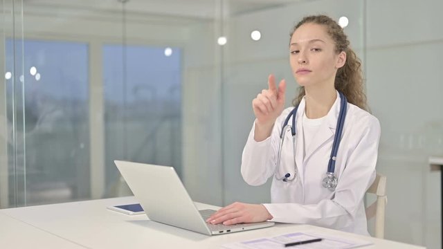 Beautiful Young Female Doctor Pointing at Camera