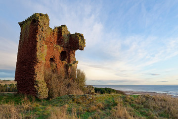 The Keep of the Red Castle at Lunan Bay in Angus, its walls beginning to tilt towards the Sea on a...