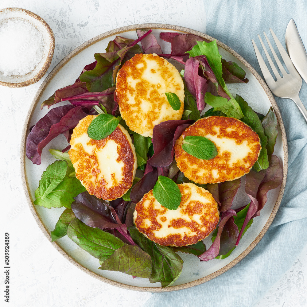 Wall mural Cyprus fried halloumi with salad mix, beet tops. Lchf, pegan, fodmap, paleo, scd, keto, ketogenic diet. Balanced food, clean eating recipe. Top view, white background