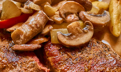 Medium fried steak with creamy mushroom sauce and vegetables