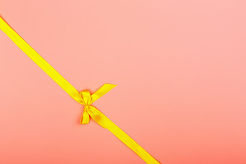 Christmas pink background. Yellow ribbon.