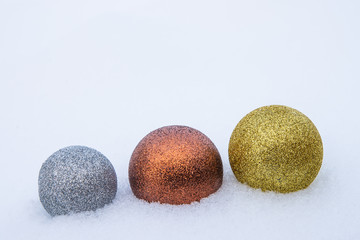Multi-colored Christmas toys in the snow