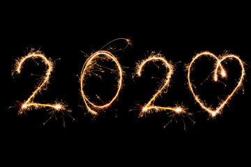 Obraz na płótnie Canvas 2020 written with Sparkle firework on black background, happy new year 2020 concept