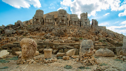 Panoramic view of some of the statues near the peak of Nemrut Dagi. King Antiochus I Theos of Commagene built on the mountain top of Mount Nemrut a tomb-sanctuary flanked by huge statues. Turkey