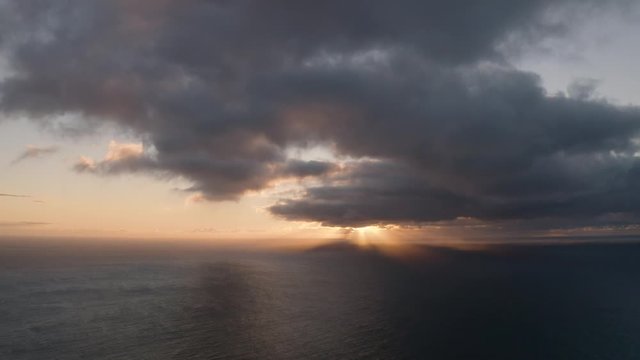 Golden sunset with dramatic light over the sea. Aerial cinematic scene. 