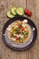 Vegetarian / Vegan Crepes stuffed witg vegetable on wooden table.