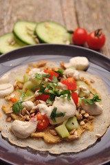 Vegetarian / Vegan Crepes stuffed witg vegetable on wooden table.