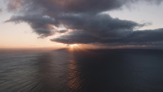 Aerial 4k view. Dramatic sunset over the sea. Beautiful cinematic scene. Flying high above the ocean.