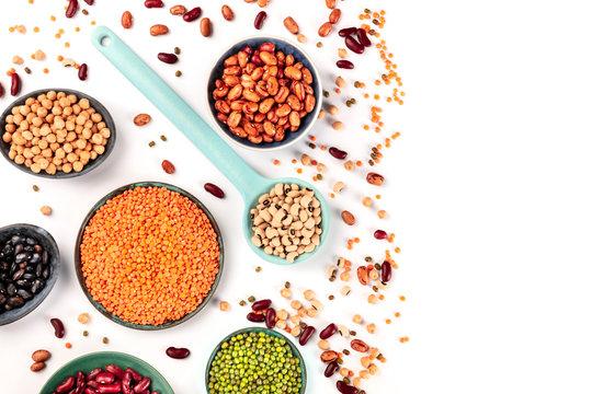 Pulses. Legumes assortment on a white background, overhead shot with a place for text. Black and red beans, lentils, chickpeas, soybeans, a flatlay with copyspace