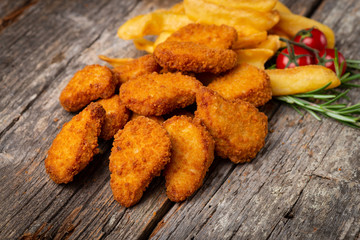 Fried crispy chicken nuggets with french fries