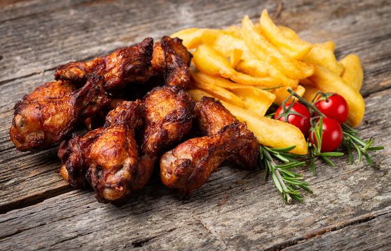 Roasted Chicken with French Fries on the wooden table