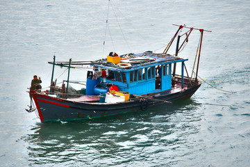 Naklejka na ściany i meble Local Fishing Boat in Ha Long Bay, Vietnam