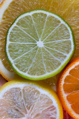 Sliced citrus fruits: orange, tangerine, lemon and lime. Food background Top view