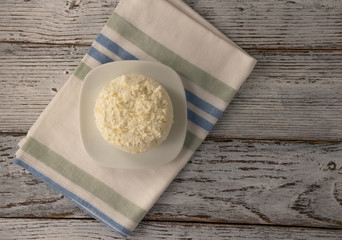 cottage cheese on a white plate on a linen napkin on an old table
