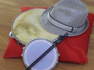 Fototapeta premium Close-up of a samba player (sambista) hat and two Brazilian percussion musical instruments: “tamborim” with drumstick and 