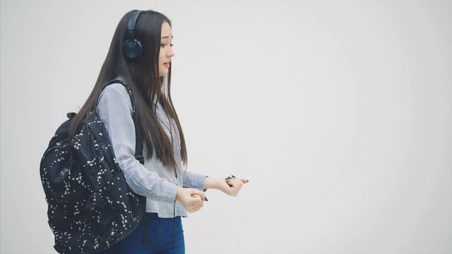 Cute young asian female student moving her hands, as if touching a wall of glass.