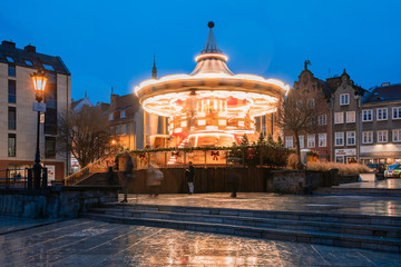 Fototapeta na wymiar Illuminated two-level original retro carousel at night in Gdansk