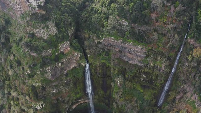 Flying over tropical waterfall scenery and green rainforest. Aerial view. Travel concept. 