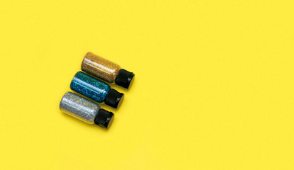 Colorful glitters on a flat lay photo, can fit for banners or craft instagram, with a yellow background