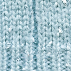 Knitted light blue pullover texture, closeup. Knitted fabric texture. Soft light wool background, close-up.