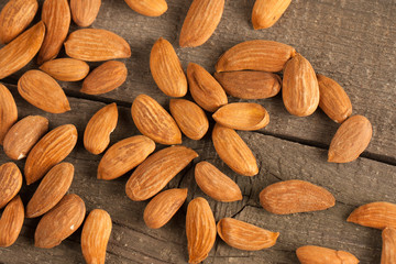 Almonds on wooden background. Healthy food concept.