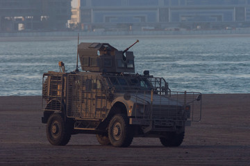 Military army vehicle close up of guns and military personel aiming and shooting.  Military and war concept of power, force, strength. - obrazy, fototapety, plakaty