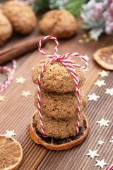 Fototapeta na wymiar Stack of homemade oatmeal cookies. Christmas healthy cookies, biscuits. Rustic wooden table. Winter decoration.