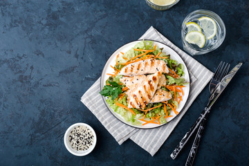 The concept of healthy diet. White grilled chicken meat with lettuce leaves on a plate