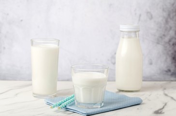 Dairy products, health concept, in glassware, on a light gray background