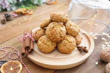 Stack of homemade oatmeal cookies. Christmas healthy cookies, biscuits. Rustic wooden table. Winter decoration.
