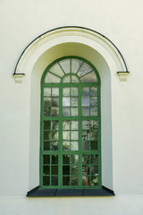 Beautiful vaulted window on a white stone wall
