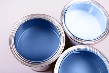 Paint brushes placed on top of can filled with blue paint. Classic blue color of year 2020