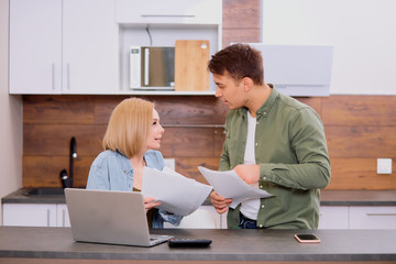young caucasian family consisted of man and woman argue about financial problems in family, discussing and calculating expenses