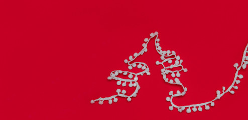 Naklejka na ściany i meble Abstract christmas tree, on a red background, made with pom poms, banner can fit with text