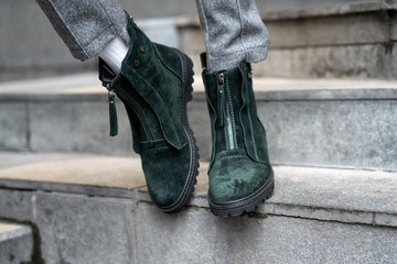 Close-up green womens shoes from nubuck demi season flat-toed on feet in the street in real conditions