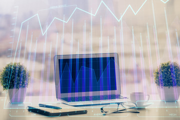 Stock market graph and table with computer background. Double exposure. Concept of financial analysis.