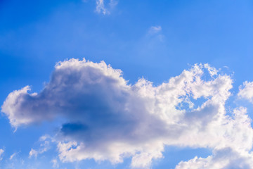Dramatic puffy fluffy clouds isolated against blue skies