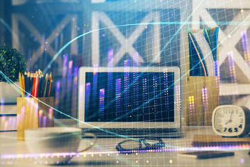 Double exposure of chart and financial info and work space with computer background. Concept of international online trading.