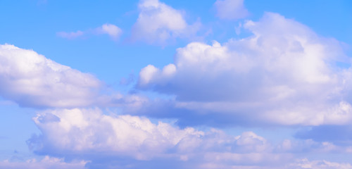 Dramatic puffy fluffy clouds isolated against blue skies