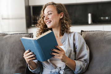 Cheerful young blonde haired woman listening to music