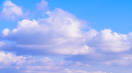Dramatic puffy fluffy clouds isolated against blue skies