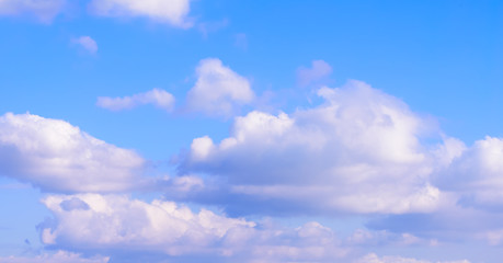 Dramatic puffy fluffy clouds isolated against blue skies