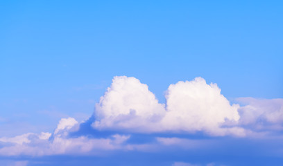 Naklejka na ściany i meble Dramatic puffy fluffy clouds isolated against blue skies