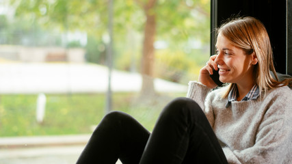 Beautiful woman talking on phone. Young woman on phone call.
